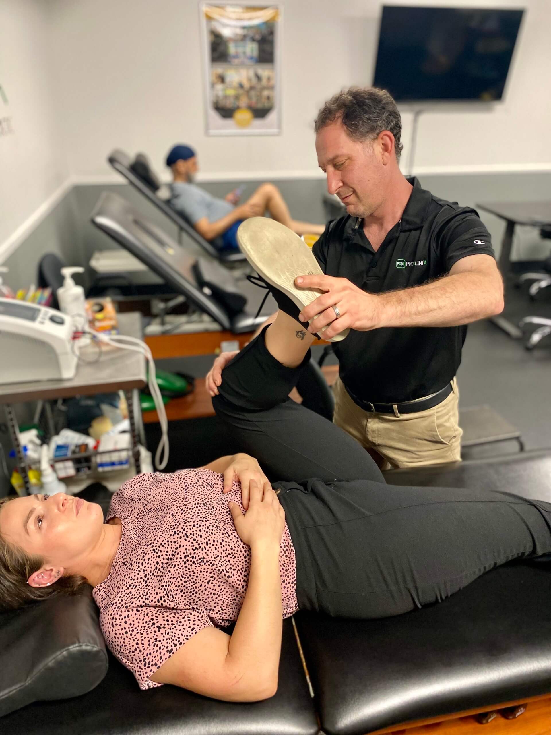 ProClinix Sports Physical Therapy & Chiropractic - Adam Pliskow, PT, MS stretching this patient for low back and hip pain